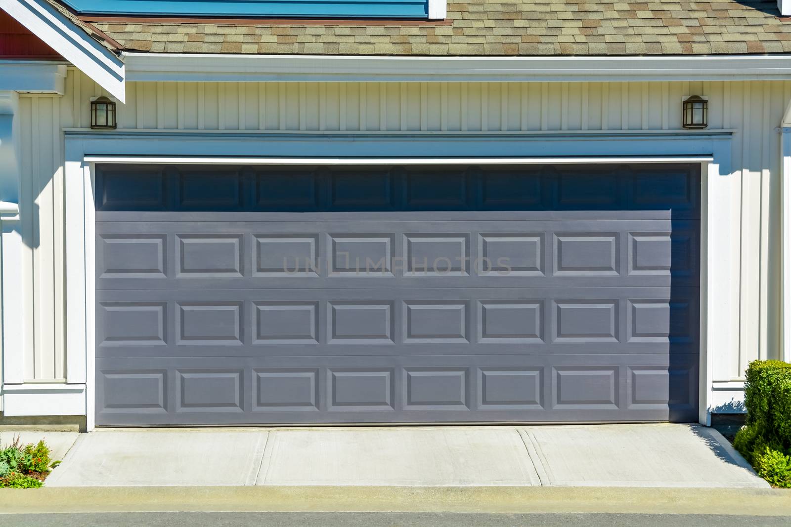 Nice and comfortable neighborhood. Wide garage door of new home in suburbs of Vancouver, Canada