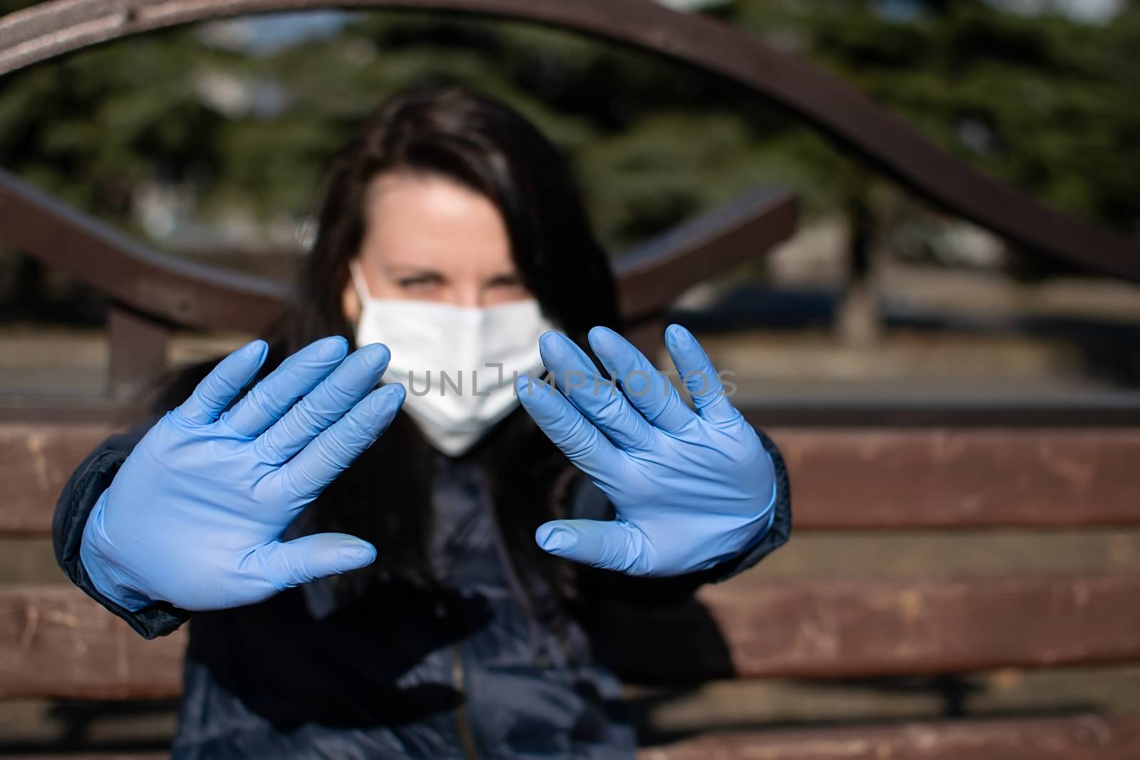 the girl, holding out her hands in rubber medical gloves and an anti-virus mask, warns that you need to keep your distance from her