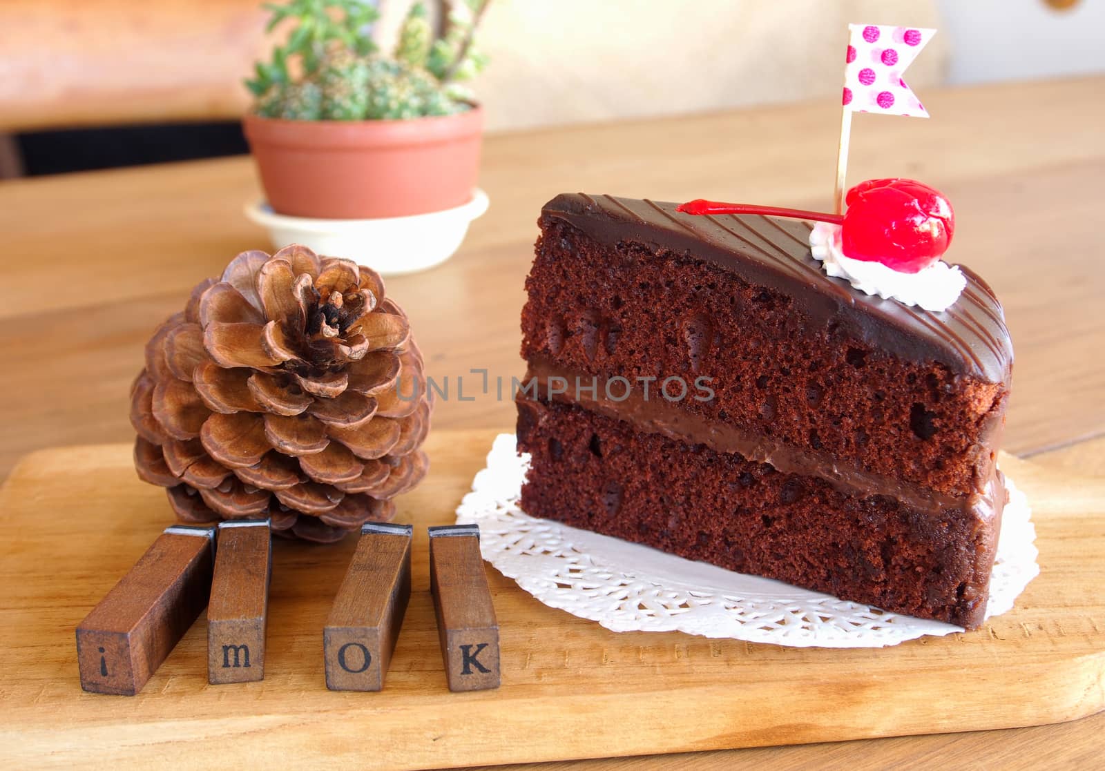 chocolate cake on wooden plate in cafe