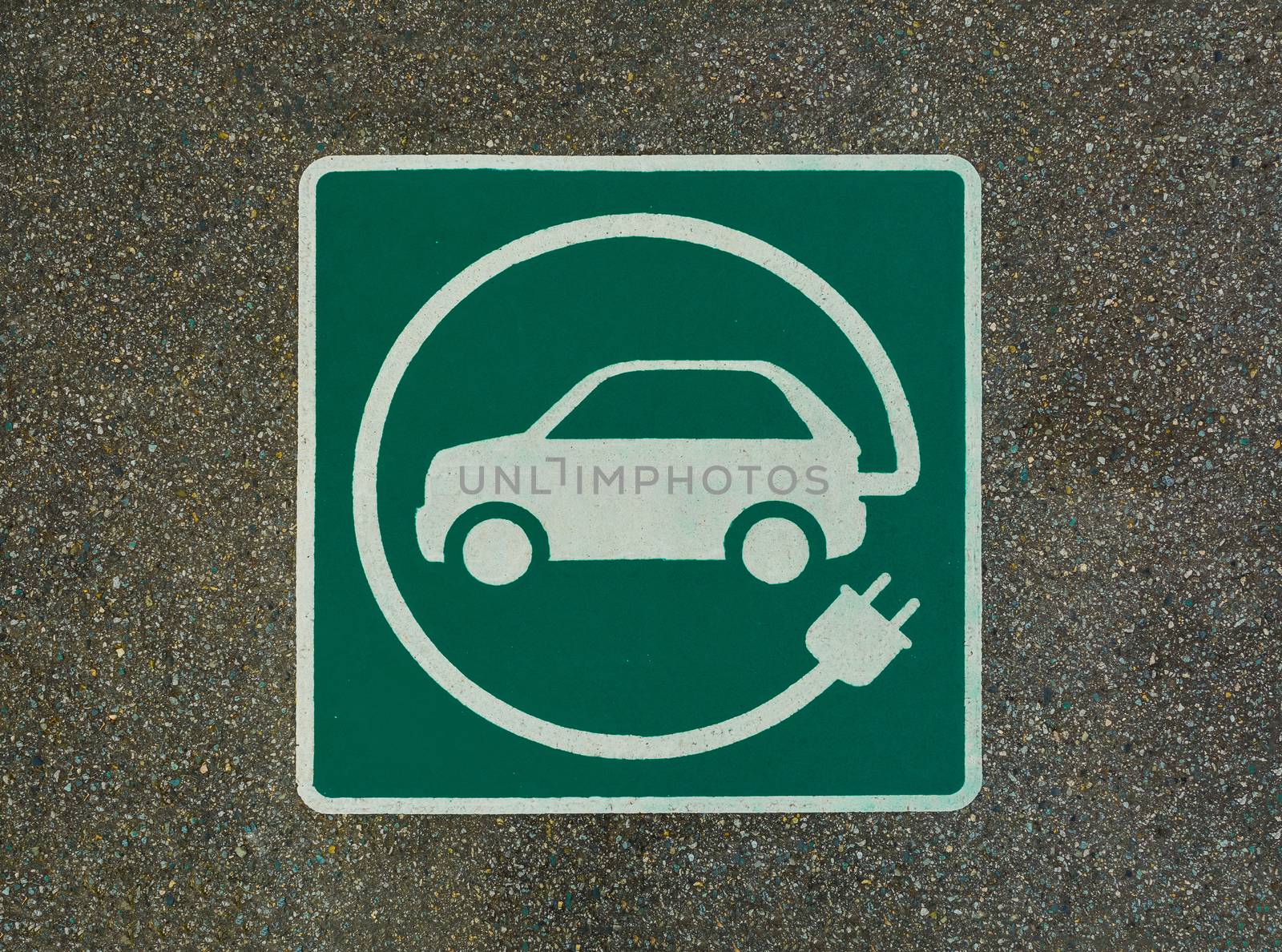 EV - electric vehicle charging station sign on asphalt. 'E' sign on asphalt texture