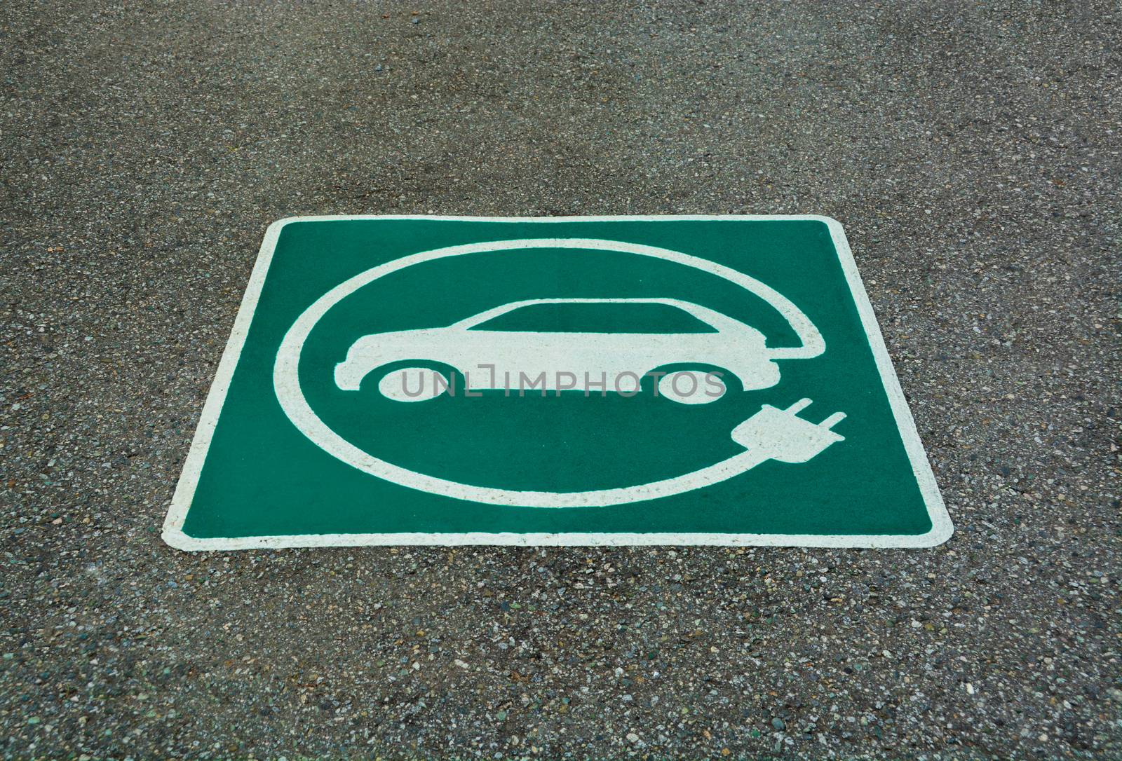 EV - electric vehicle charging station sign on asphalt. 'E' sign on asphalt texture