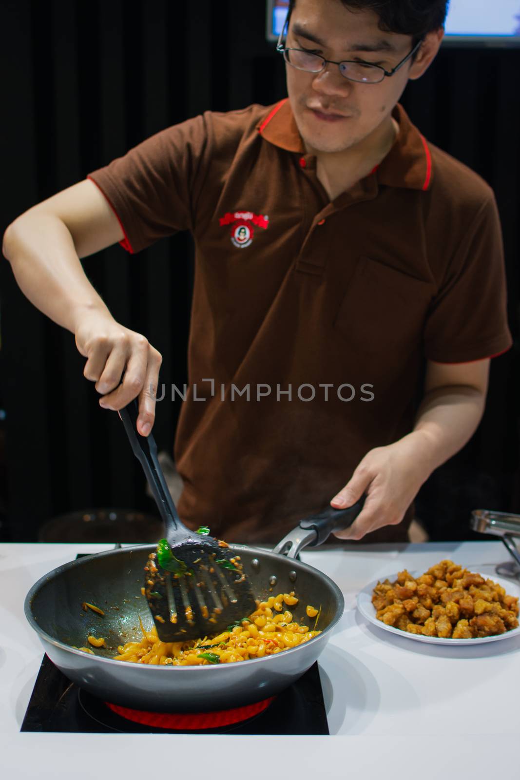 Bangkok, Thailand - May 29, 2016 : Unidentified chef cooking a food for show and sale to customers in the coffee and food exibition show event OTOP.