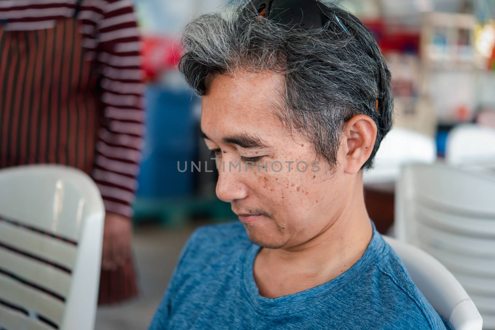 Asian handsome man eating thai food with rice and many food on dining table in restaurant with happy and enjoy emotion