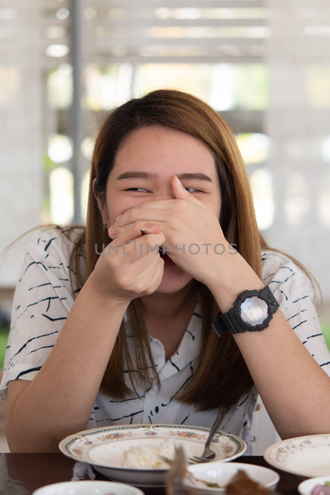 Asian pretty cute woman eating thai food with rice and many food on dining table in restaurant with happy and enjoy emotion