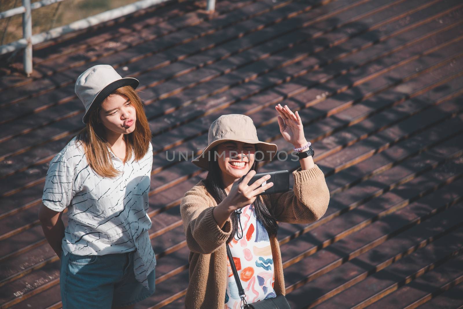 Asian pretty cute women with hat relax and use smartphone at seaside city landscape viewpoint on mountain with happy and freedom emotion in concept travel, vacation, leisure in life