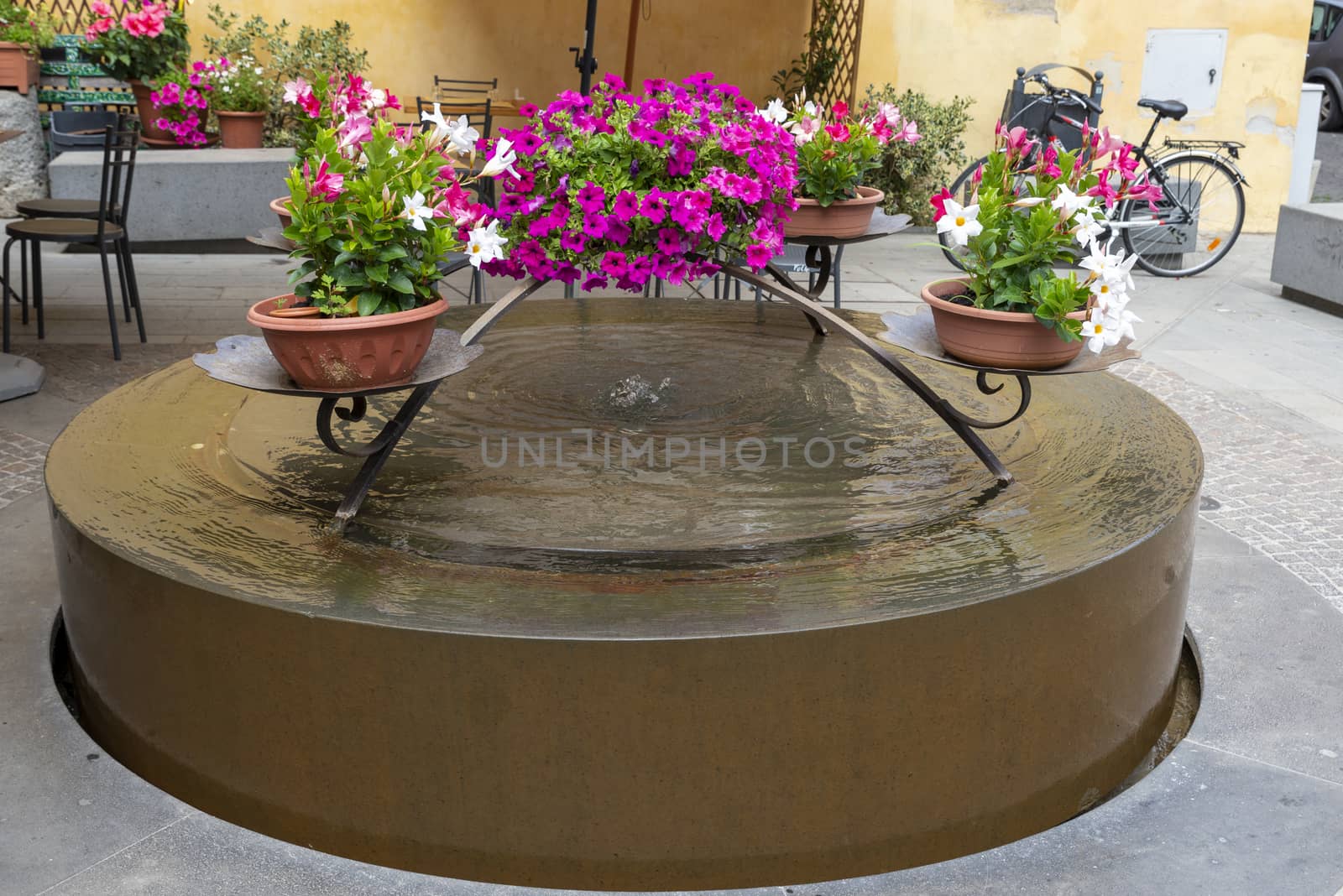 fountain with flowers designed and built in a small square in Orvieto