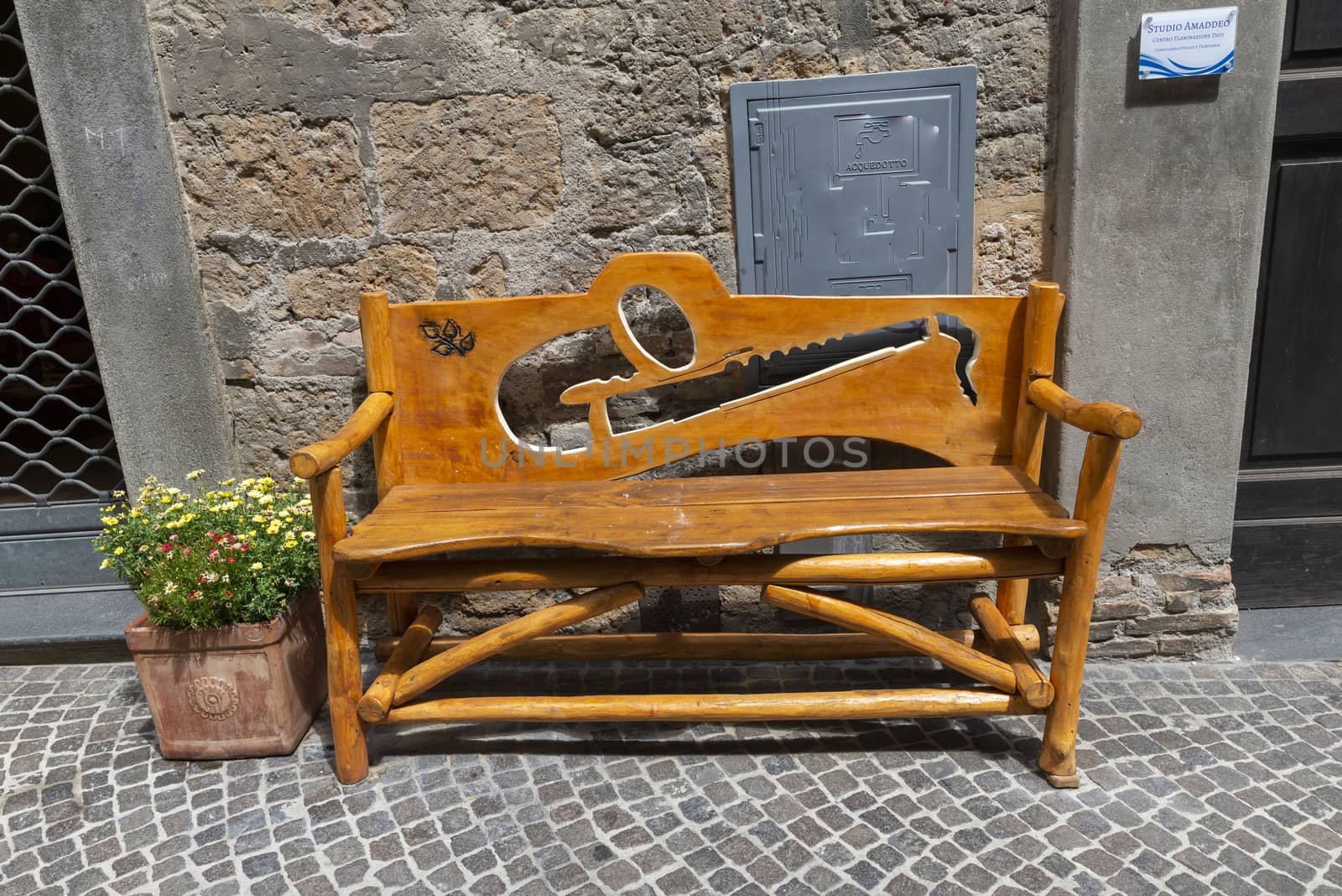 handmade wooden bench with light brown carved wood