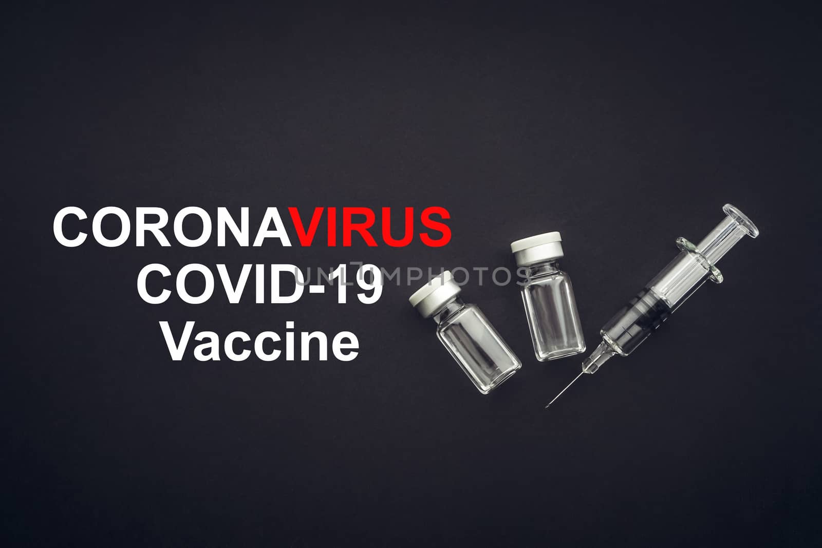 CORONAVIRUS COVID-19 VACCINE text with syringe and vials on black background by silverwings