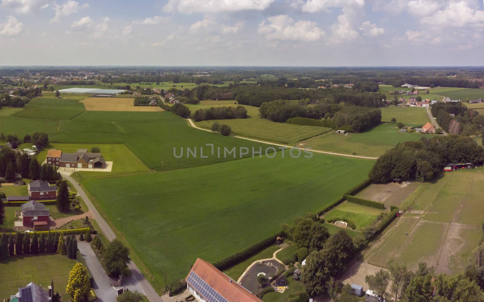 Aerial panorama view on a countryside area in Belgium with houses and agricultural fields by kb79