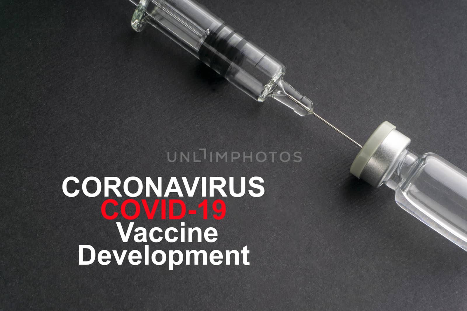 CORONAVIRUS COVID-19 VACCINE DEVELOPMENT text with syringe and vials on black background. Covid-19 and Coronavirus concept