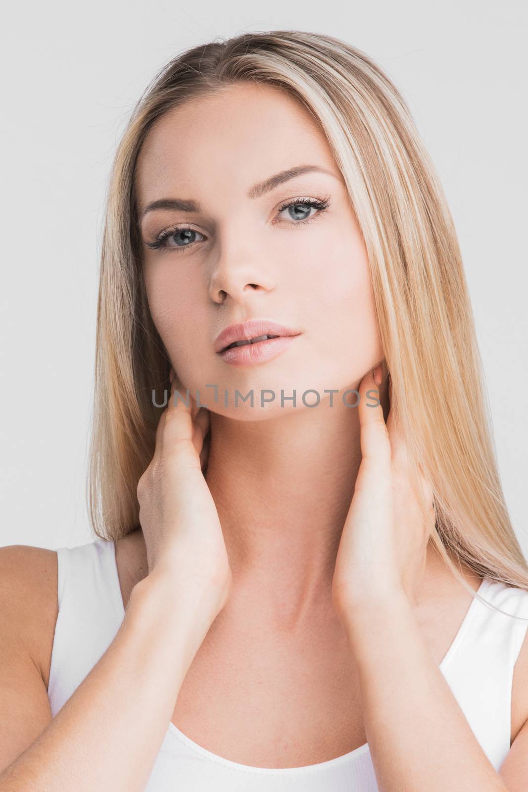Beautiful blonde woman with long straight hair on a white background beauty skincare concept
