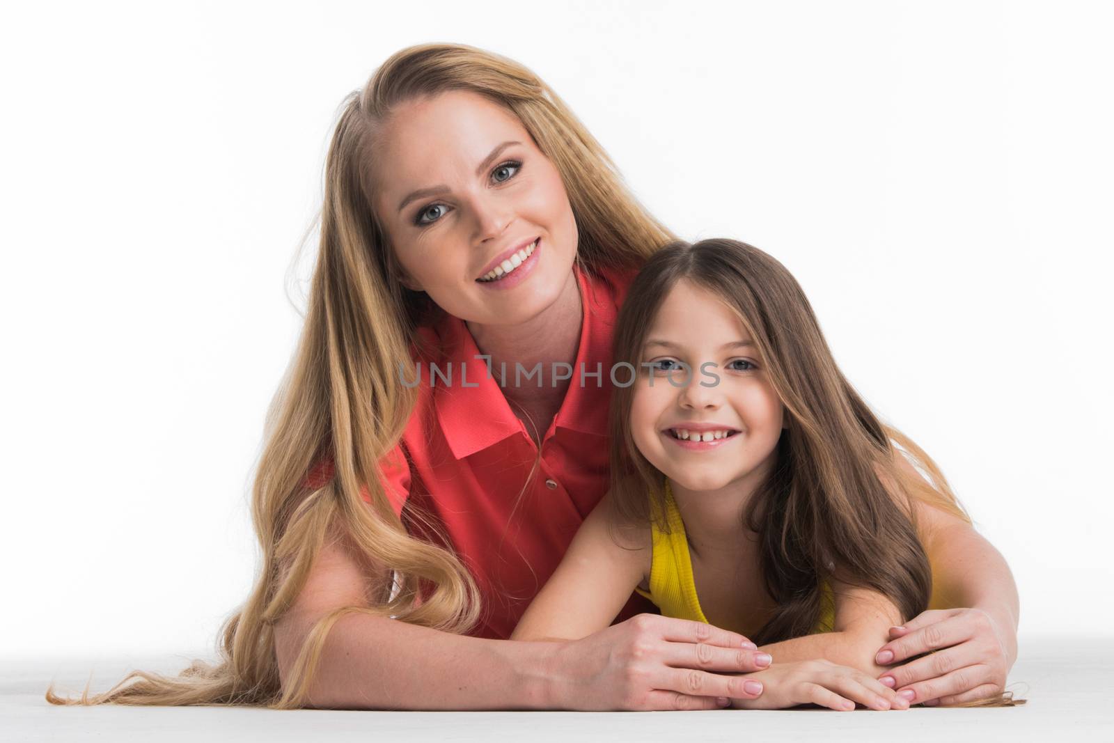 Mother and teenager daughter lying down isolated on white background