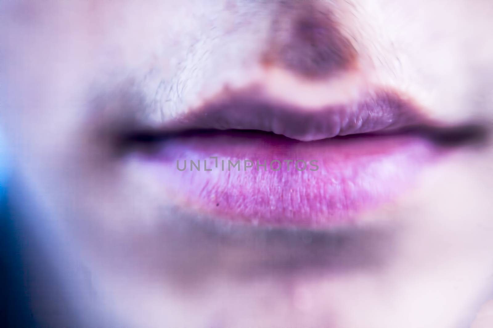 Close up of dried rough lips of a male teenager.