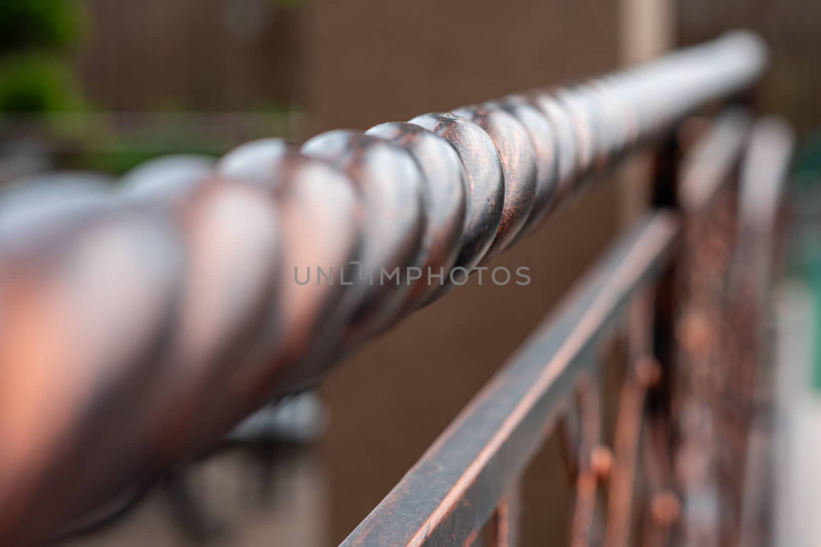 Wrought and twisted iron handrails. Metal products. Stylization of design in the old style