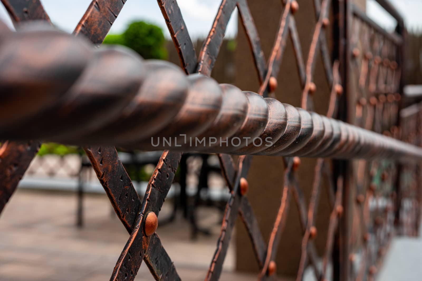 Wrought and twisted iron handrails. Metal products. Stylization of design in the old style