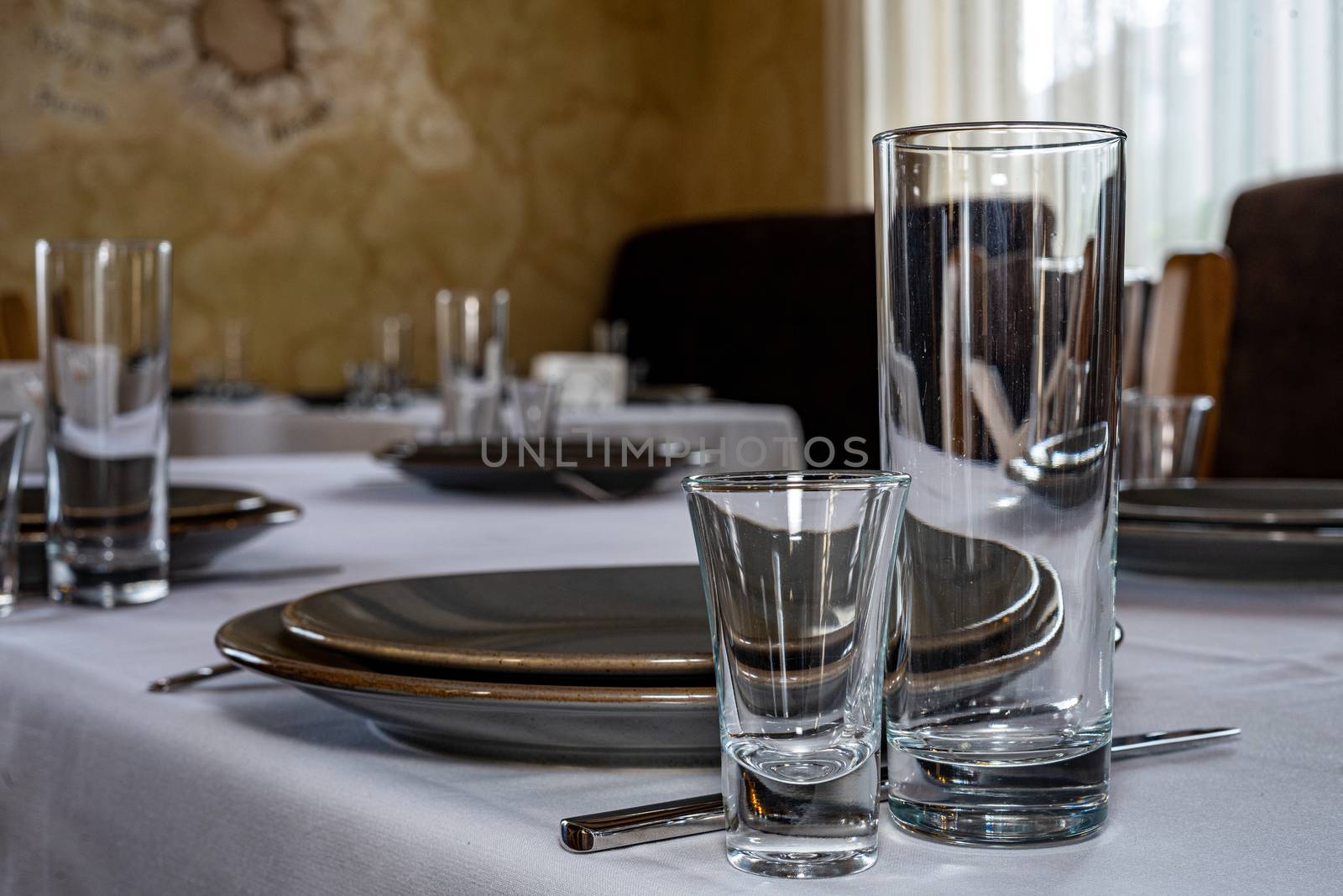 Table setting. Cutlery. Glass, stack, bowls and fork on the table. by Serhii_Voroshchuk