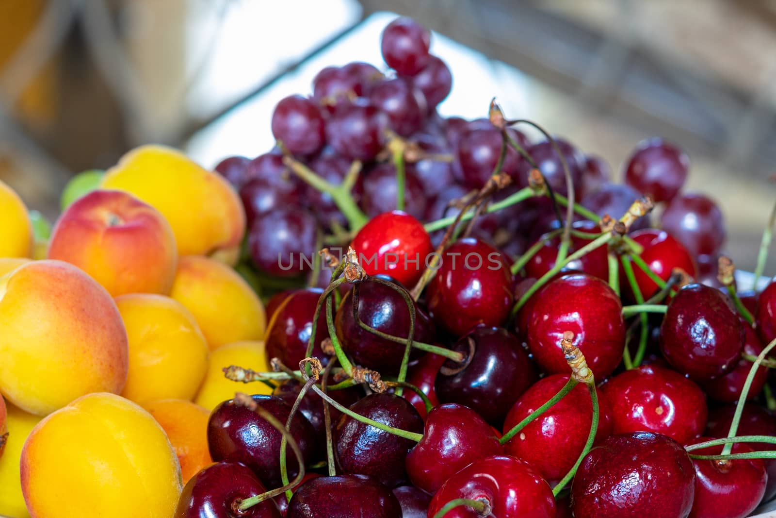 Ripe cherries, grapes and apricots. Fruit plate. Bright fruits by Serhii_Voroshchuk