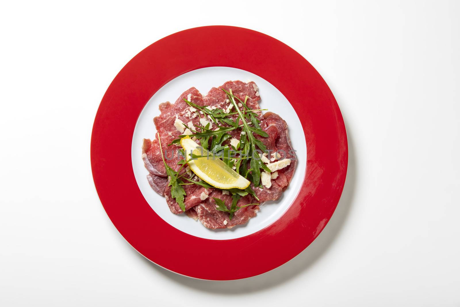 fresh carpaccio with rucola on a plate