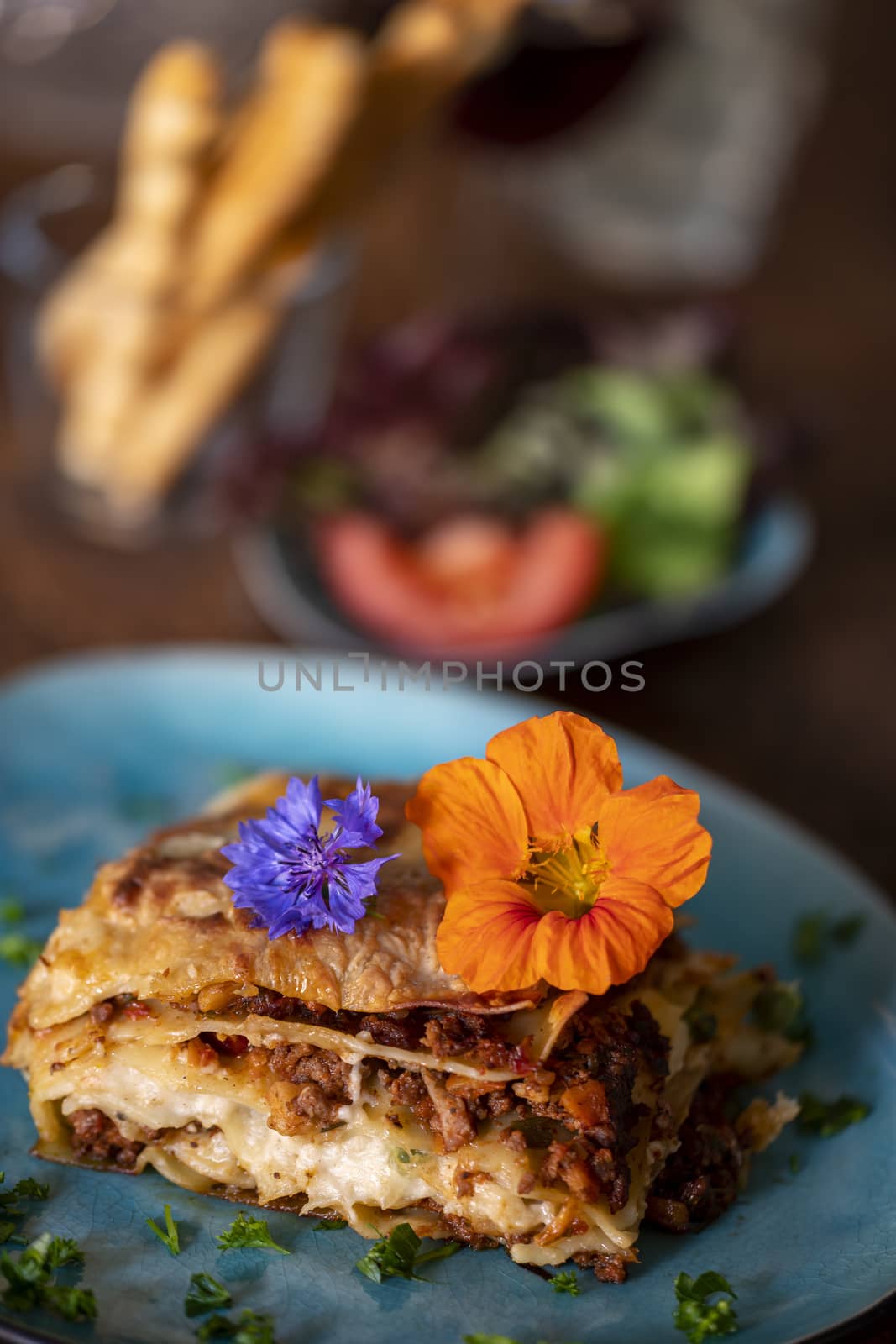 lasagna on a blue plate by bernjuer