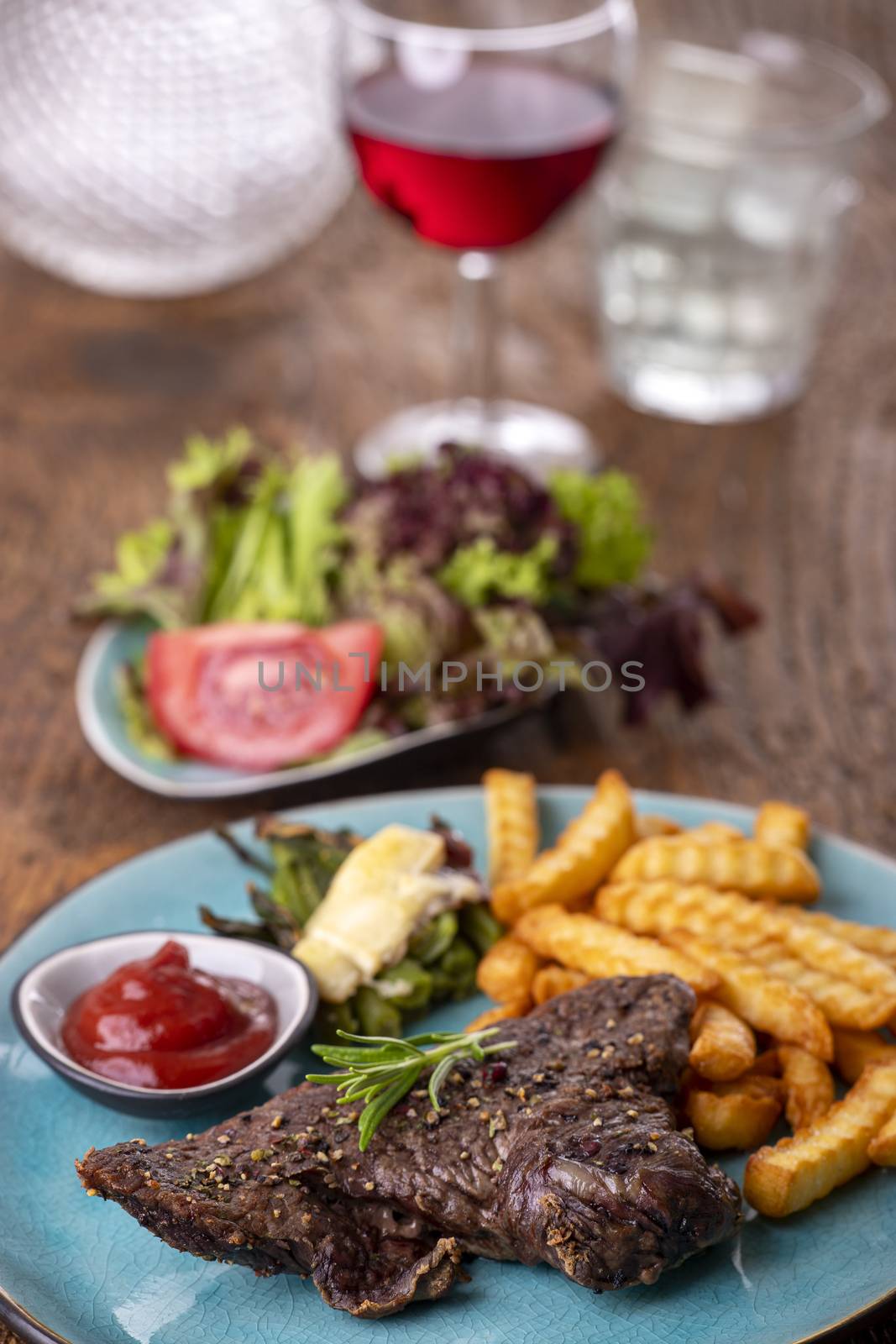 rosemary on a steak with fries