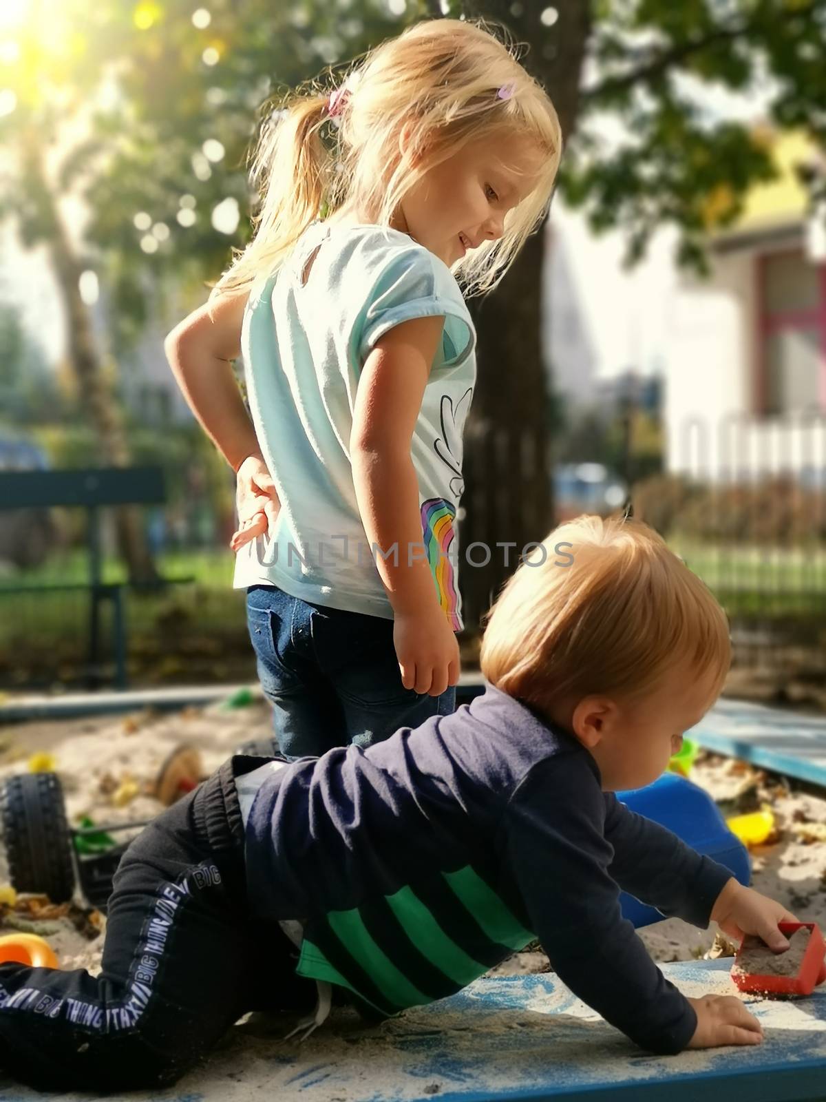 Sister and brother playing with sand. Adorable little kids famil by wektorygrafika