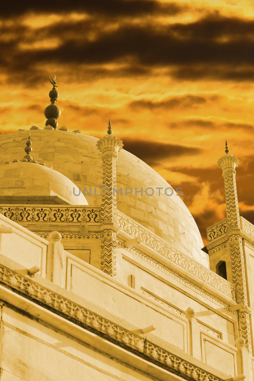 The minars of the Taj Mahal under the stormy cloudy skies.