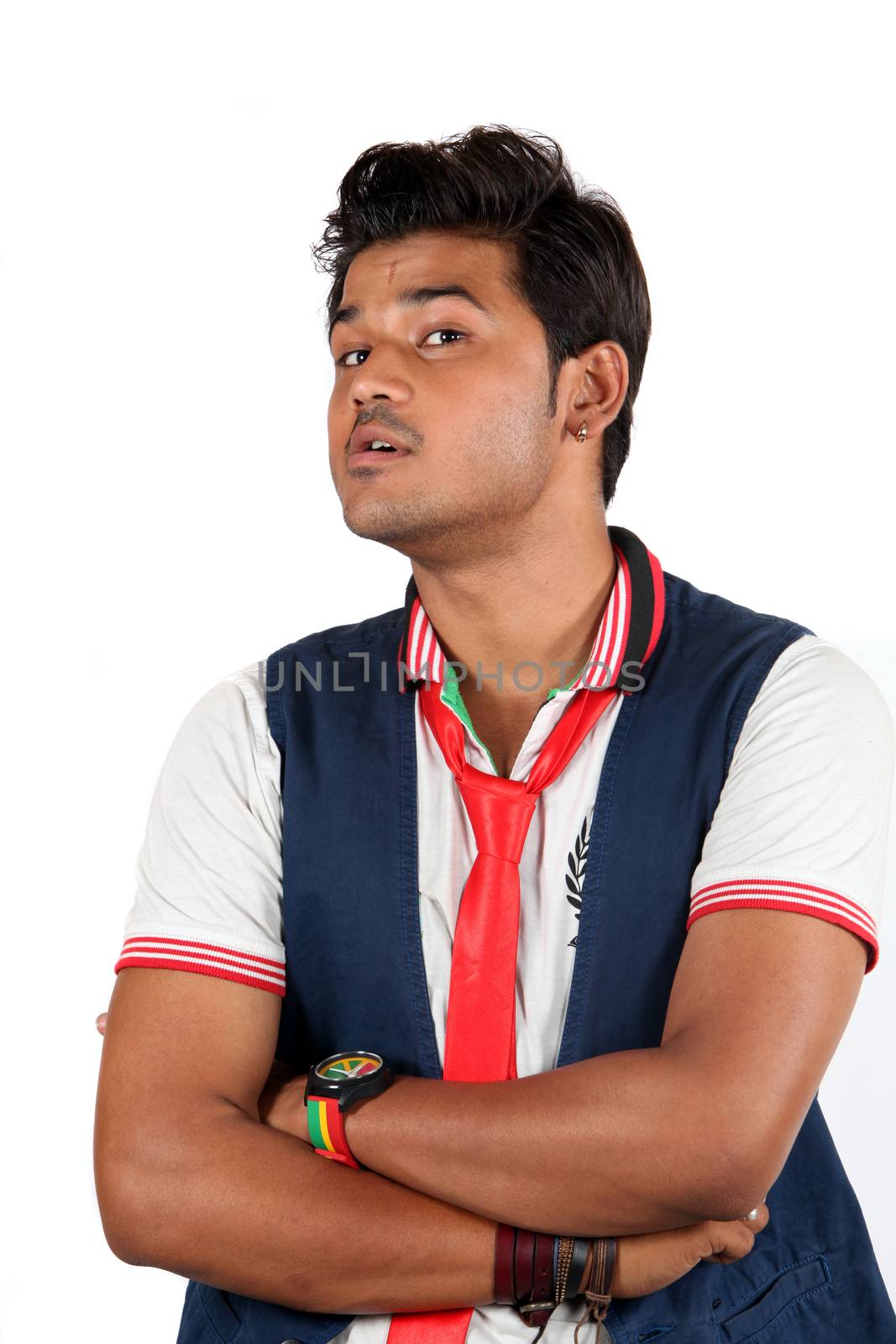 A young Indian guy wth questioning or doubting gesture, on white studio background.