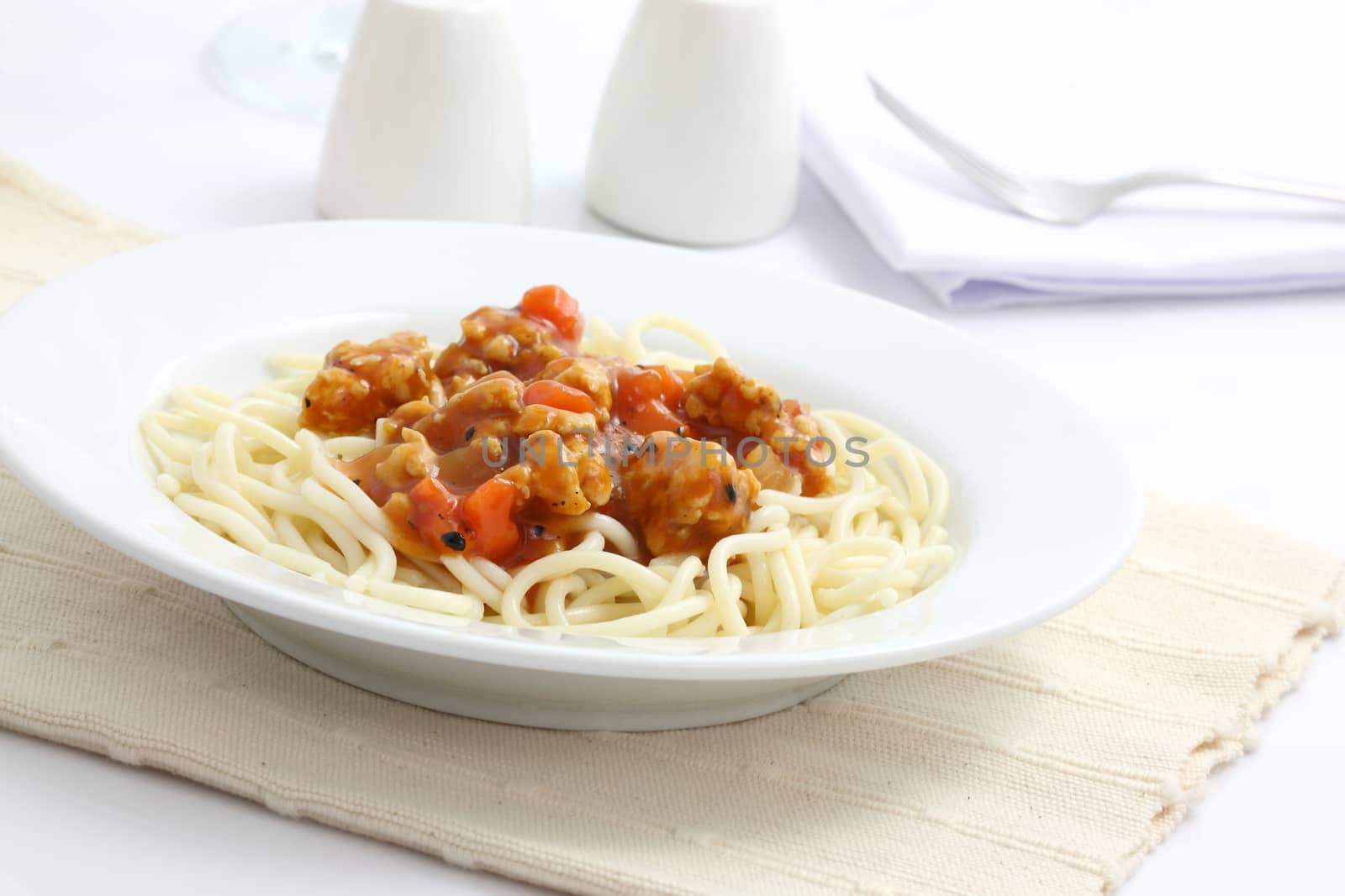 spaghetti with tomato sauce in white background by piyato