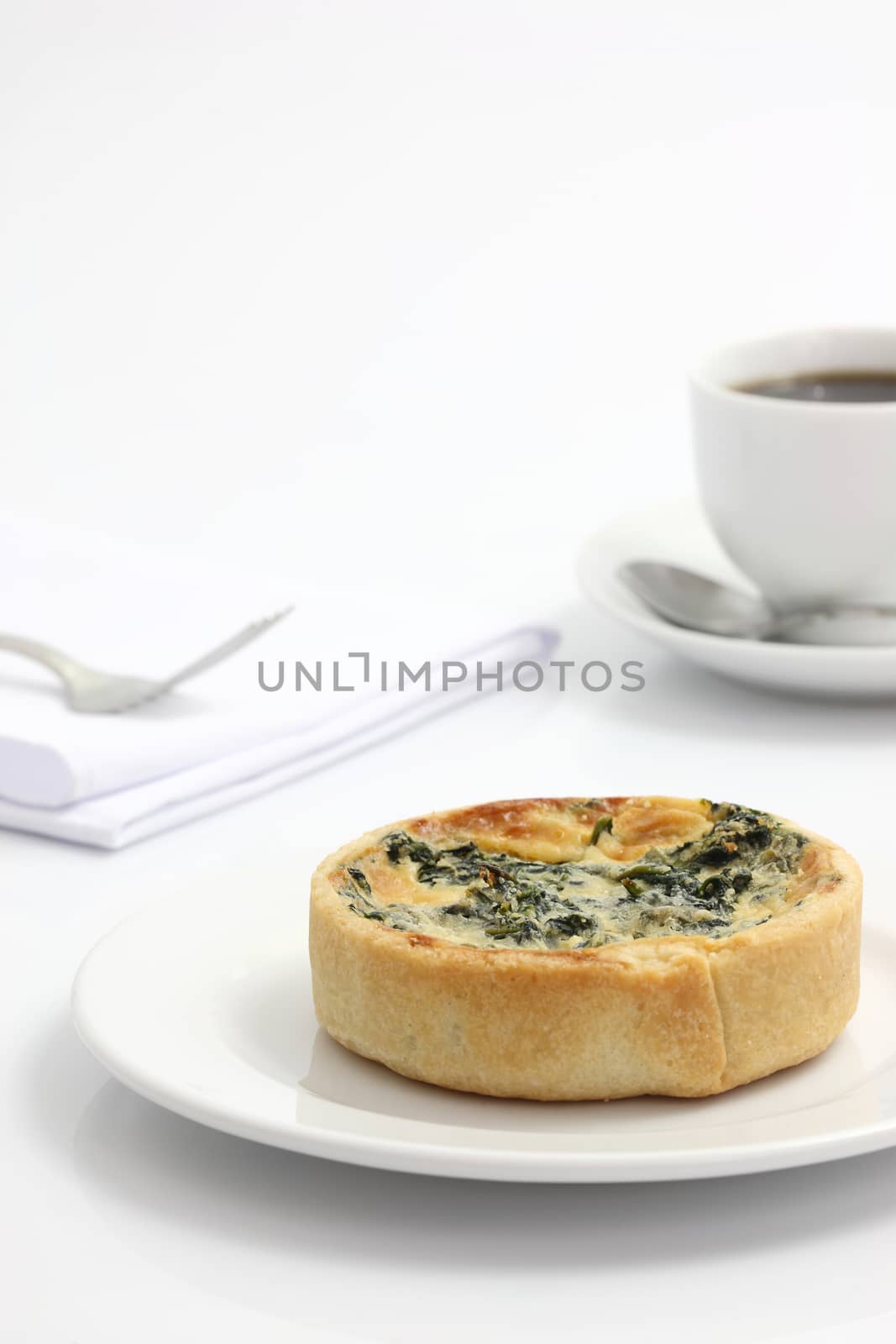 spinach quiche pie with coffee isolated on white background