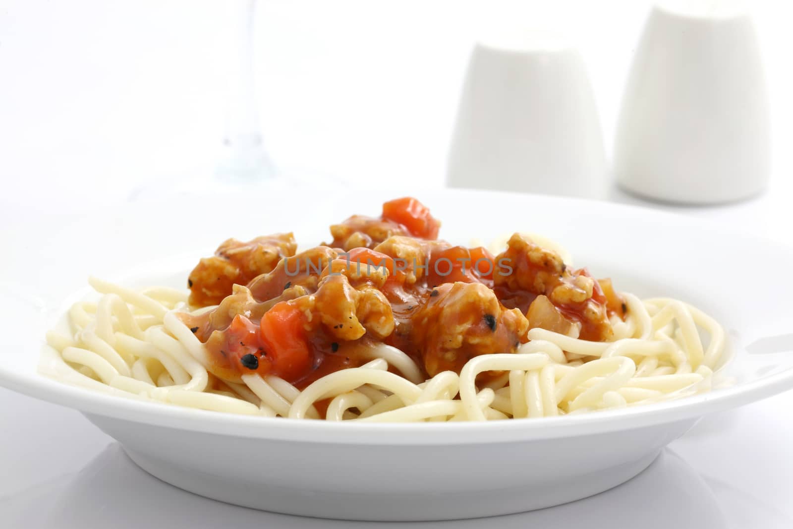 spaghetti with tomato sauce in white background