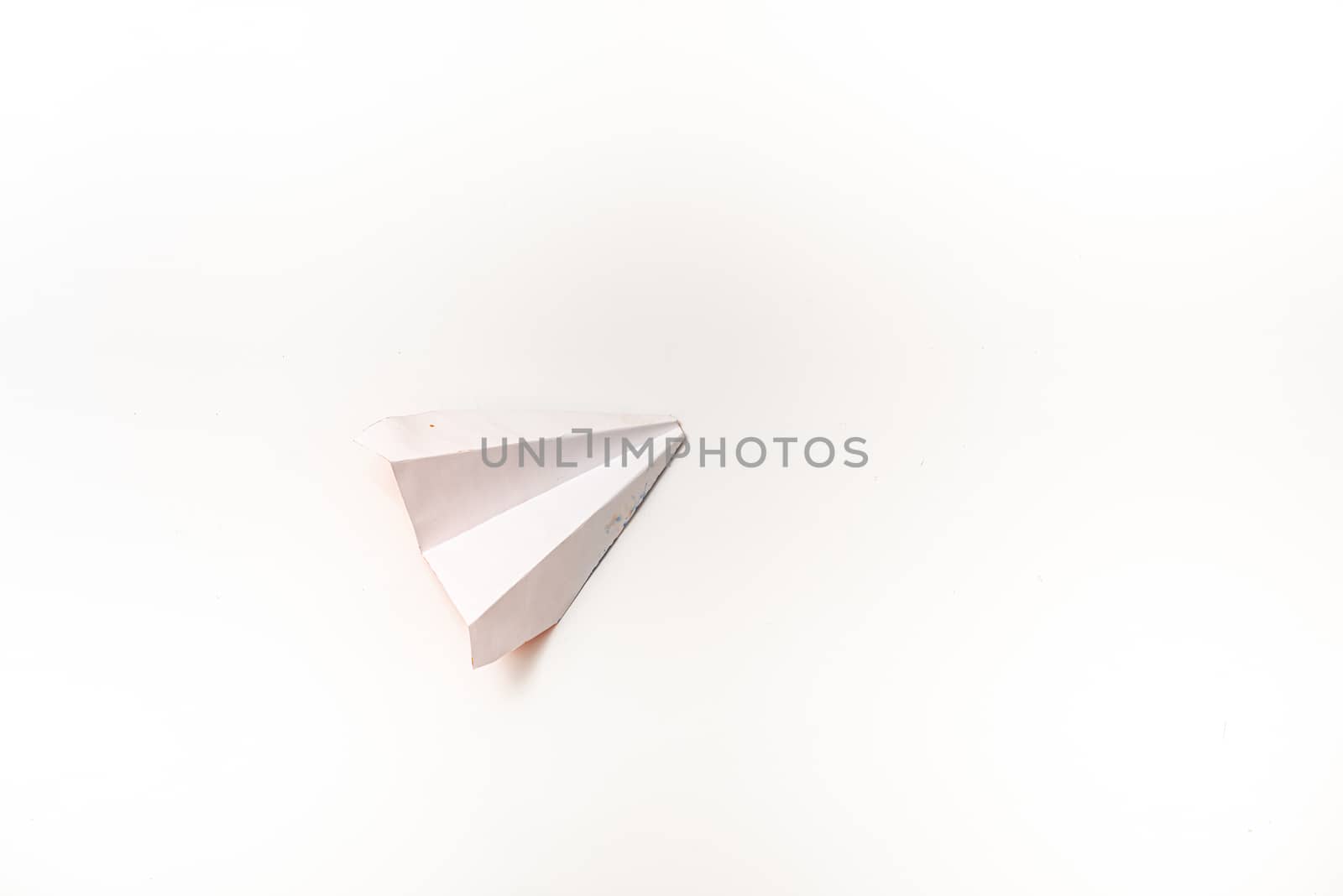 White paper plane on a white background with copy space by marynkin