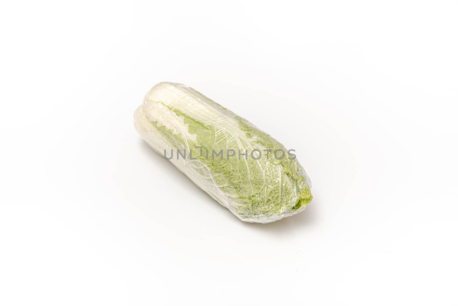 chinese cabbage packed in food film on an isolated white background with copy space by marynkin