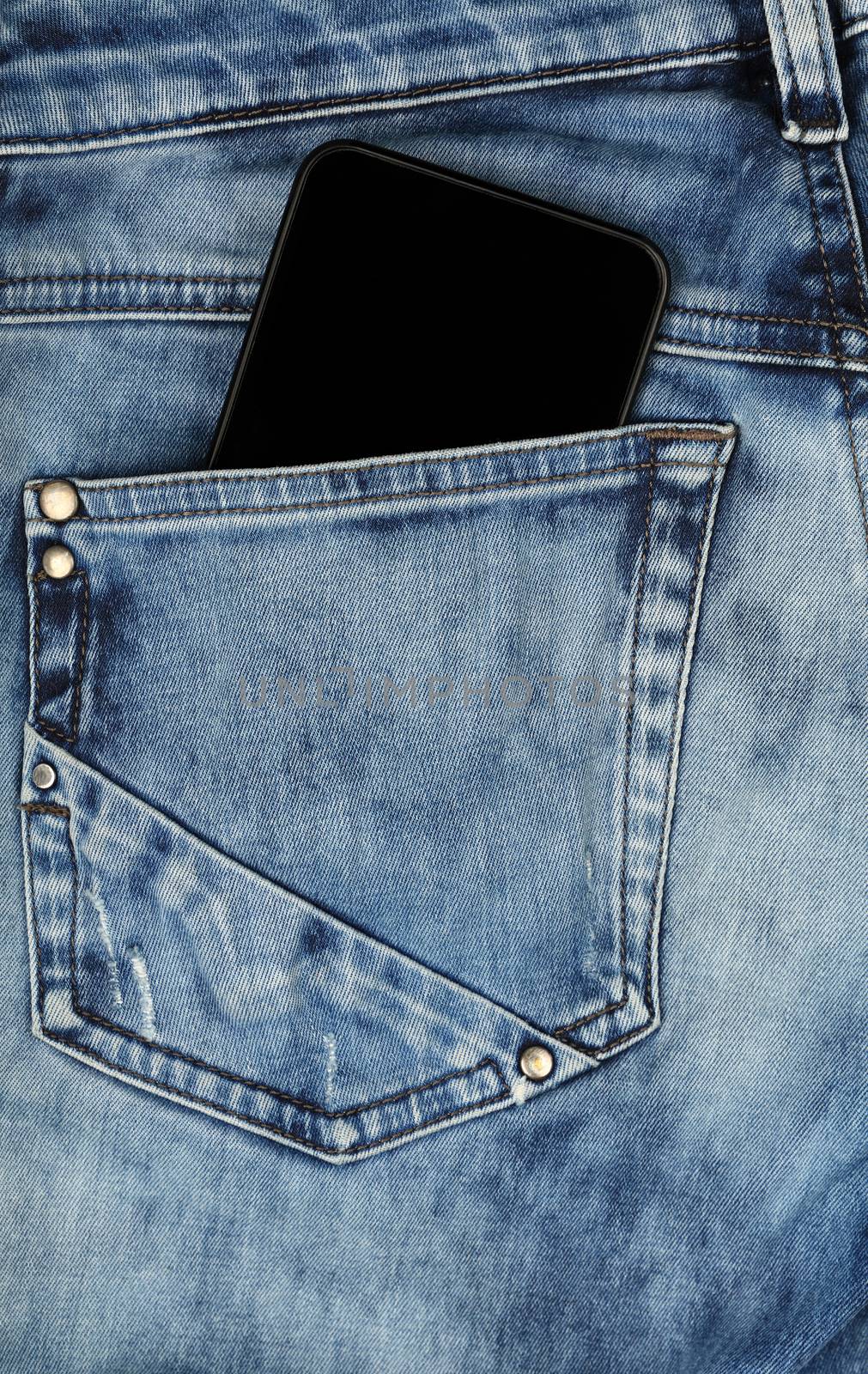 Black smartphone in jeans back pocket by BreakingTheWalls
