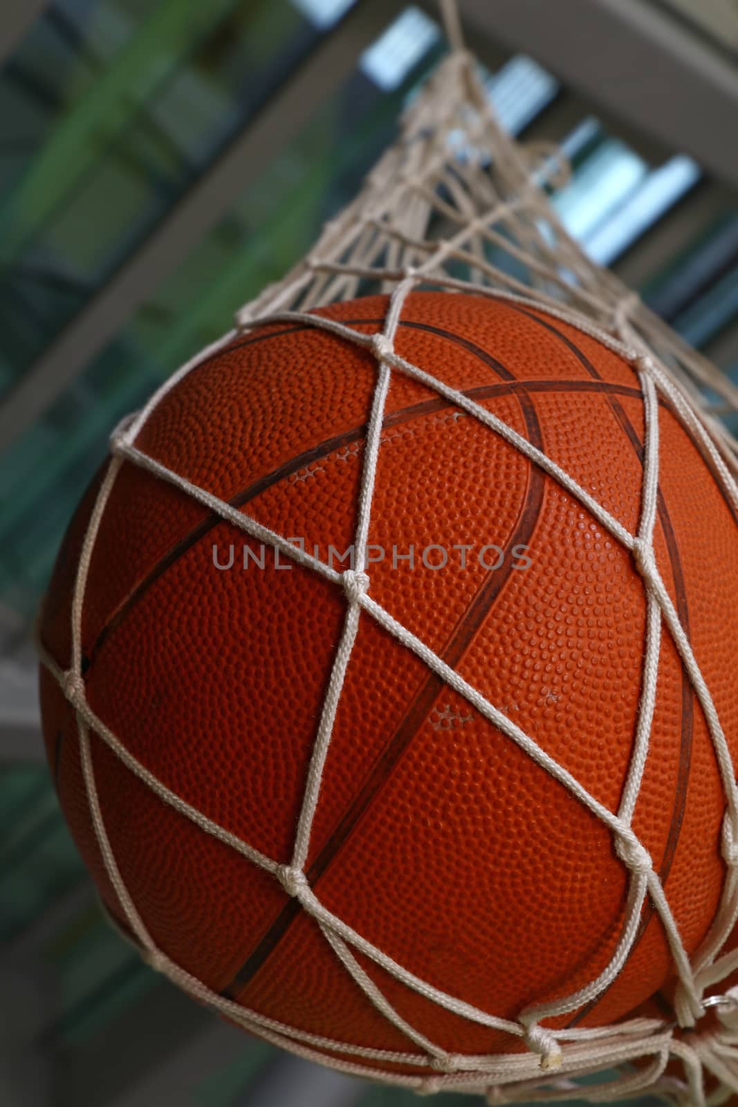 One basketball ball hanging in mesh sack by BreakingTheWalls
