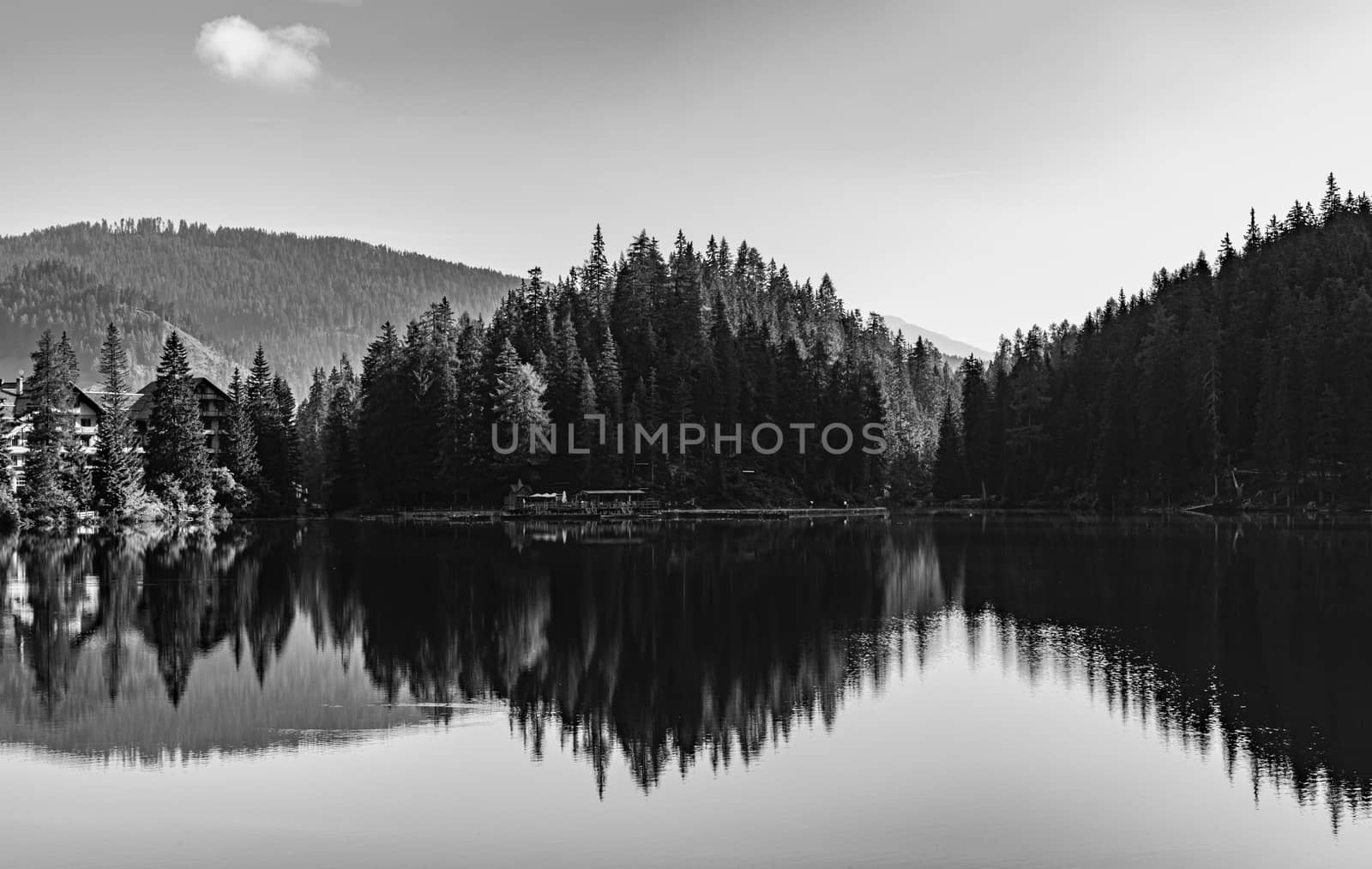 Black and white image of Lake Braies and its reflections, Italian landscape in South Tyrol