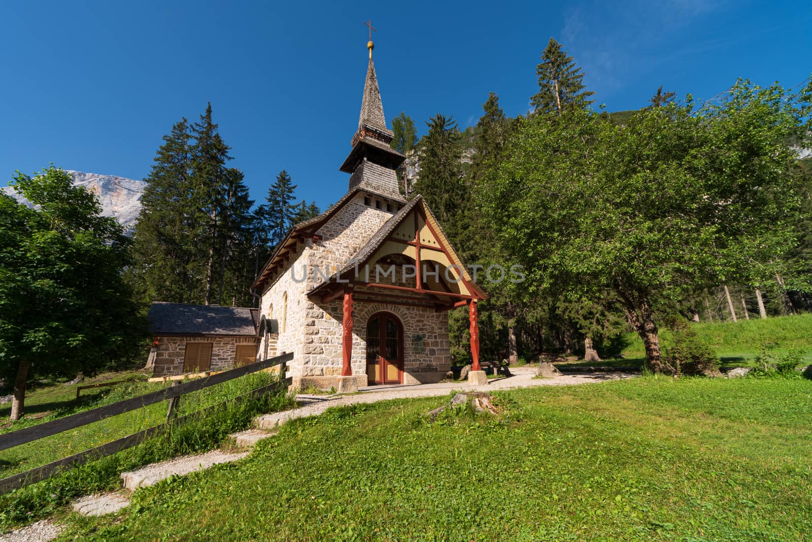 Small church surrounded by nature under the Seekofel mountains next to Lake Braies, Italian landscape in South Tyrol