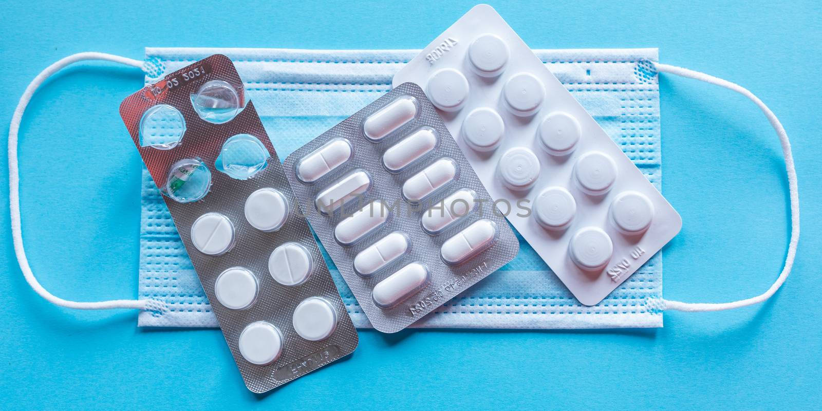 Health care prevention medical tablets pills on face mask stock photo - virus disease prevention