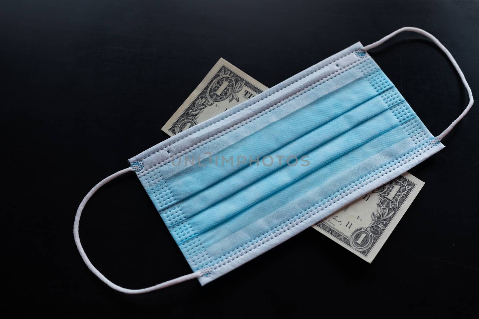 Cost of prevention corona virus - money and preventive facemask stock photo