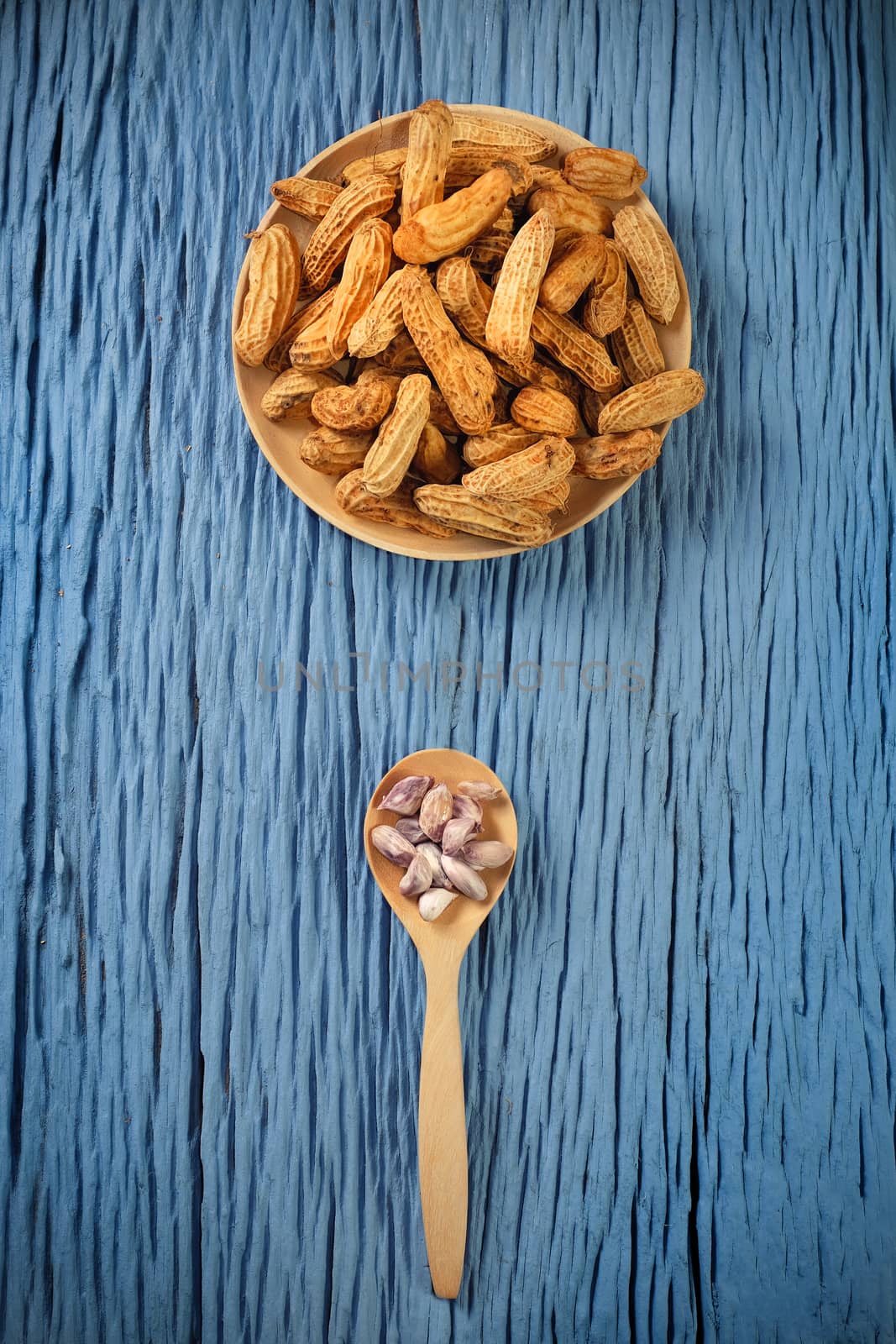 Peanuts on blue wood background