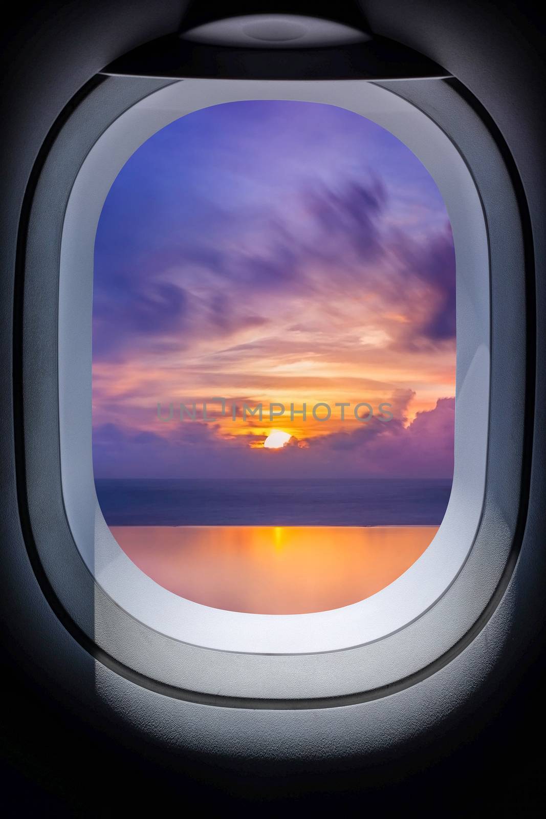 
Beautiful sunset in seascape from aircraft window by Surasak