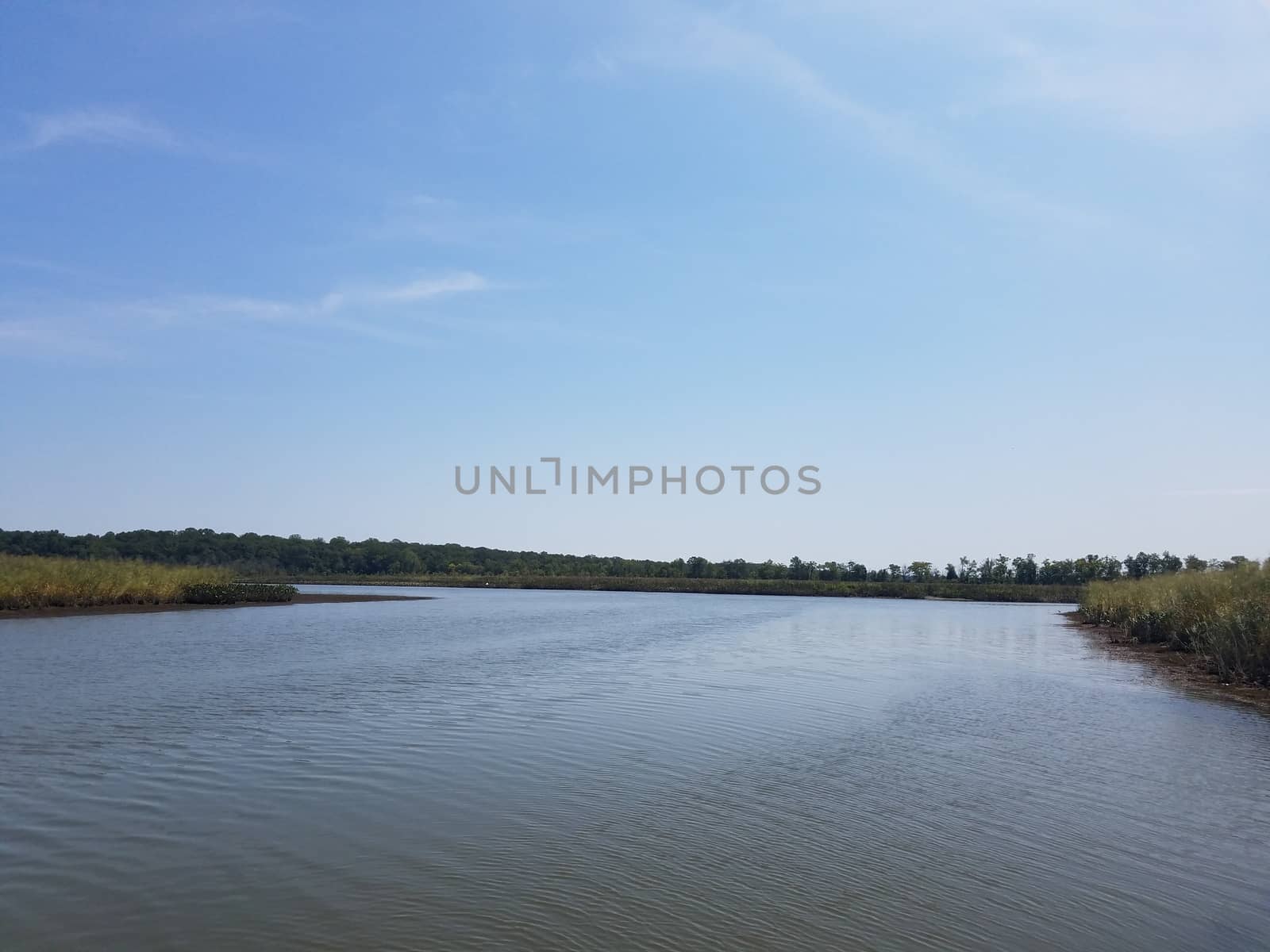 river or lake water and blue sky and grass by stockphotofan1