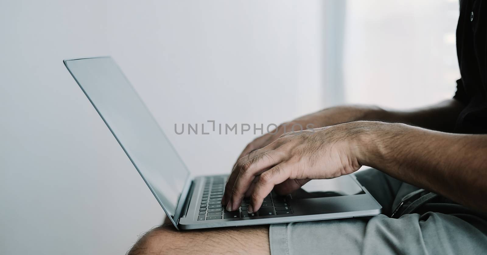 Close up man using smart laptop at home.