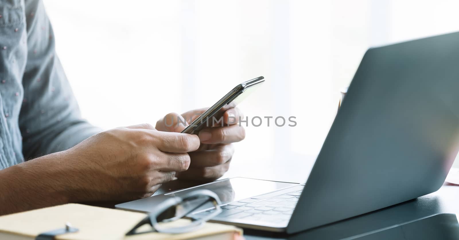Close up businessman using smart phone at office by nateemee