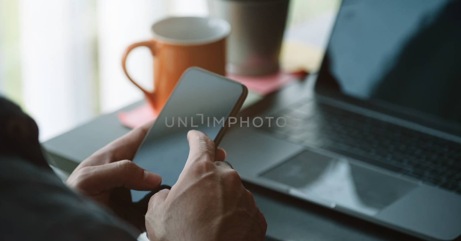 Close up man using smart phone at home by nateemee