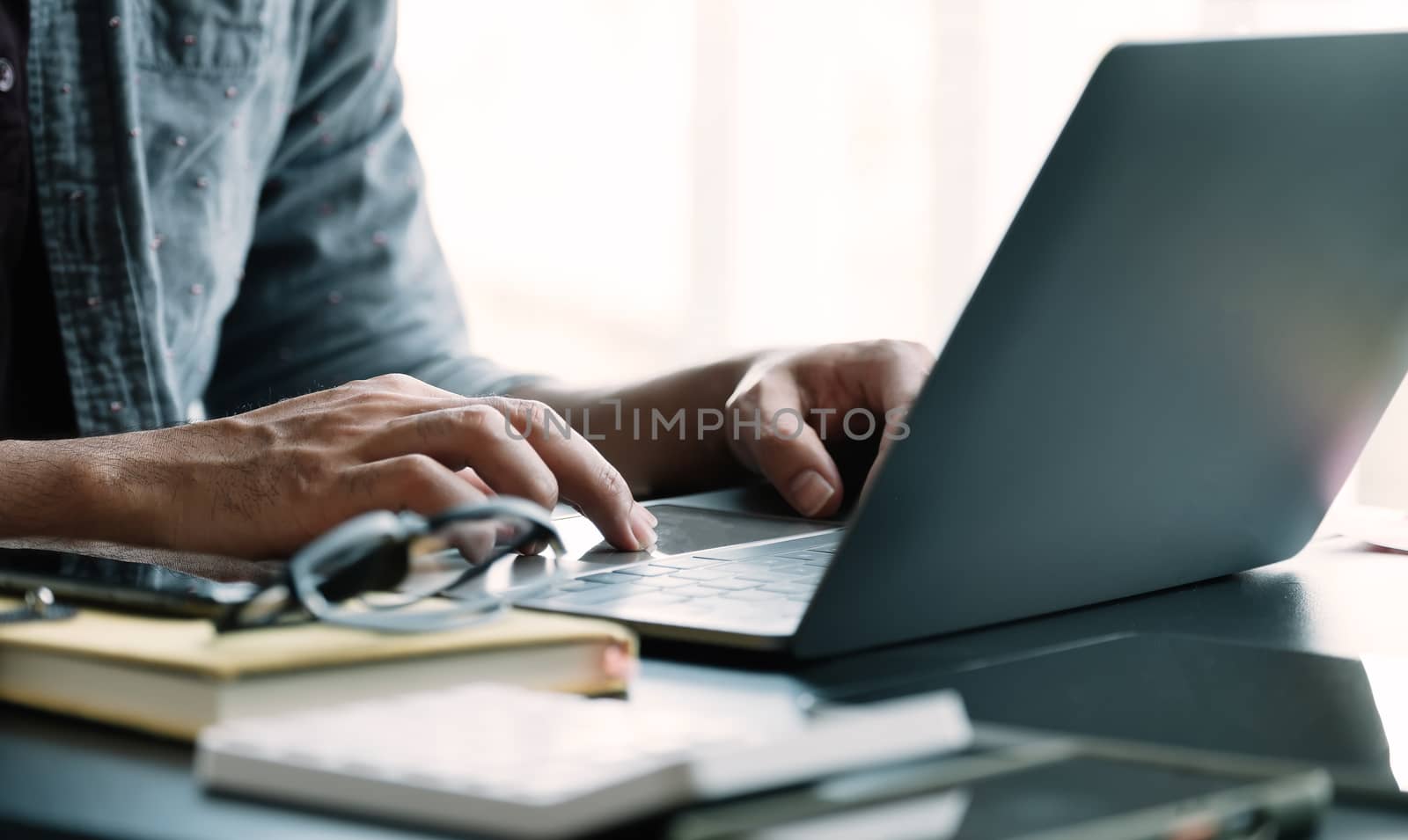 Close up businessman using laptop computer at home.