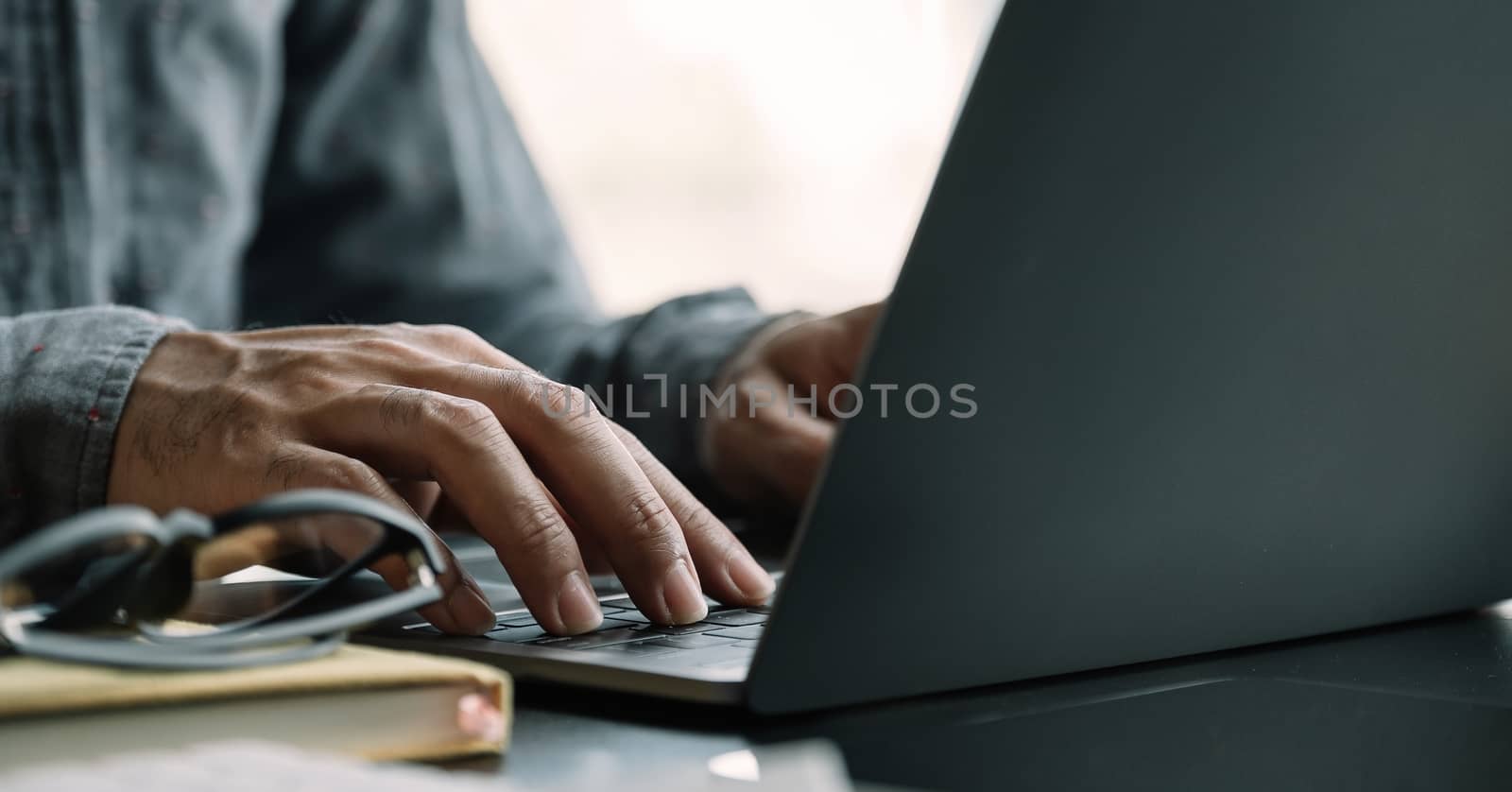 Close up businessman using laptop computer at home.