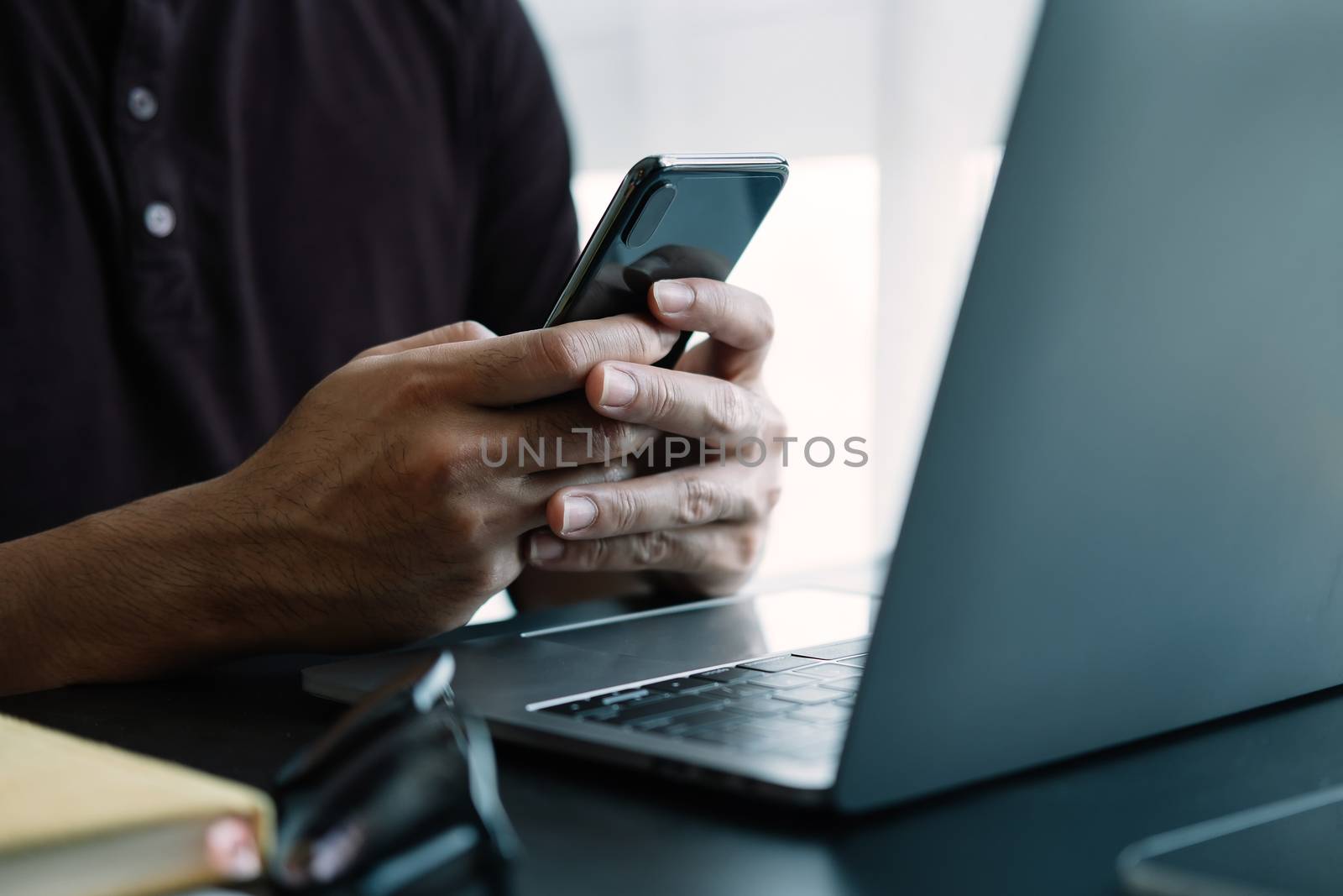 Close up man using smart phone at home.