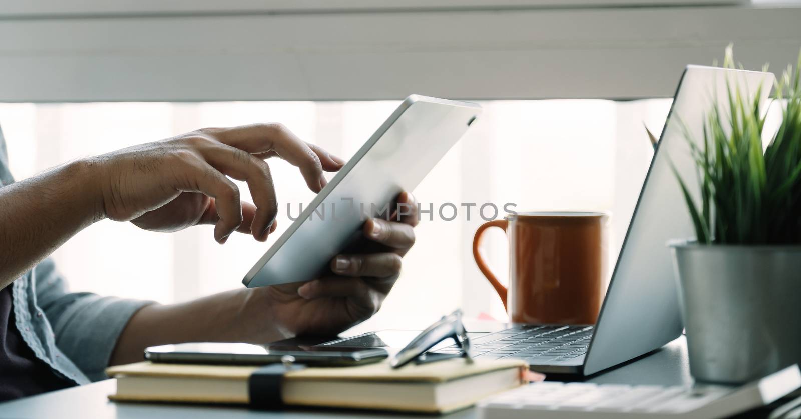 Close up man using smart laptop at home by nateemee