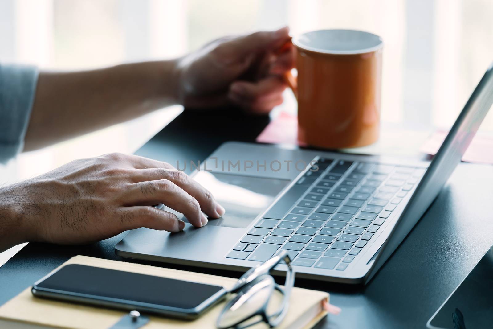 Close up man using smart laptop at home by nateemee