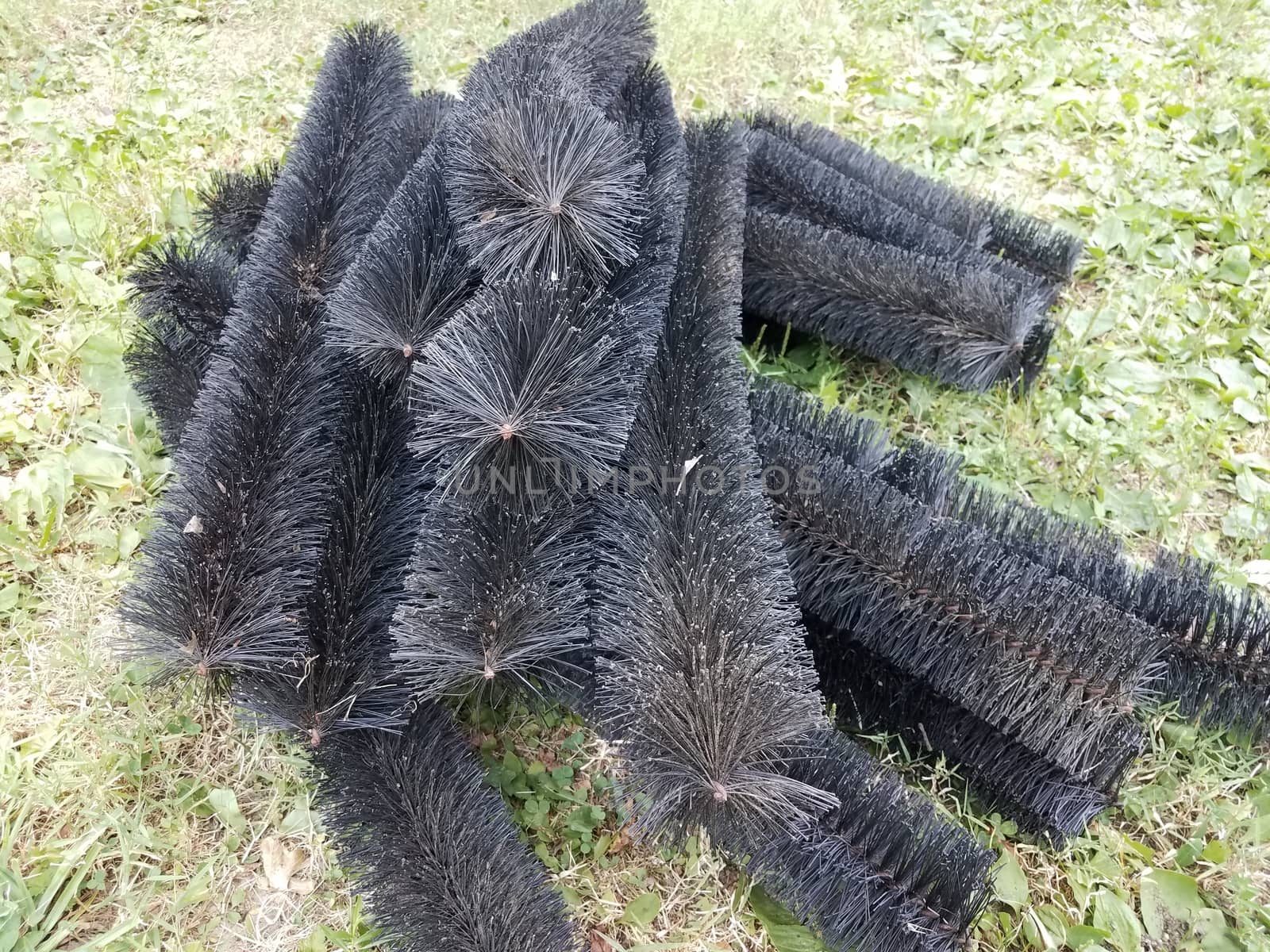 black pipe cleaner for gutters in green grass by stockphotofan1